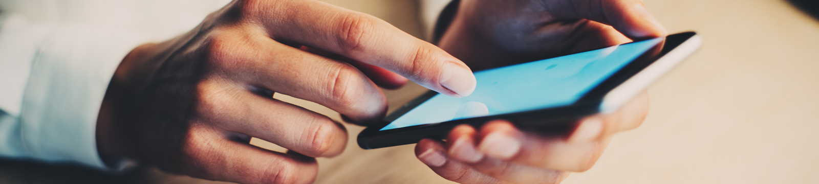 hands holding smartphone and touching screen