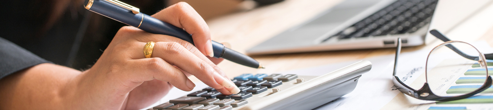 Woman's hand on calculator