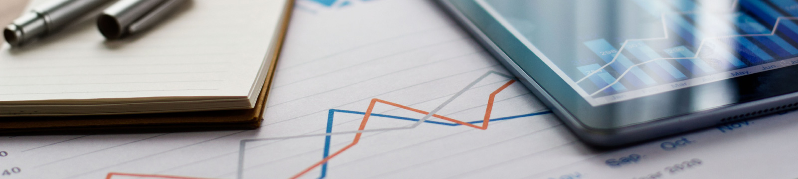 Charts, notepad and tablet on a table